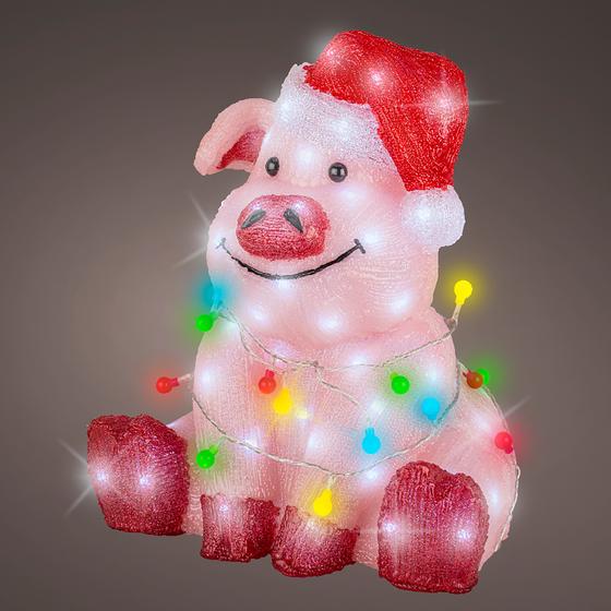 Acrylic pig with lights on dark background