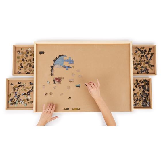 Puzzling on the puzzle table with storage drawers opened