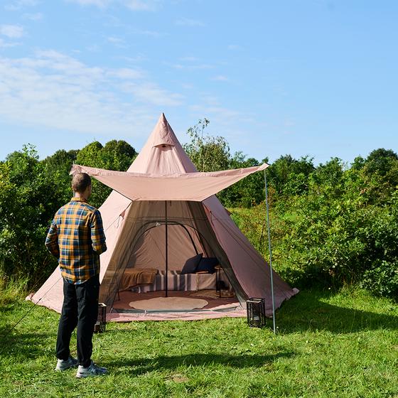 Glamping tipi tent - opened with person outside