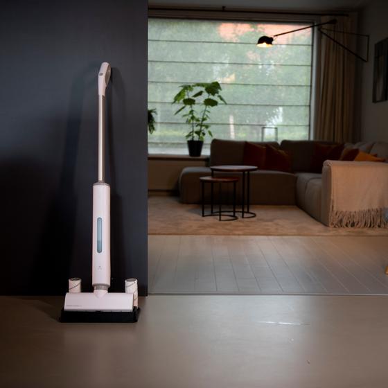 Emerio wet and dry floor cleaner is on the stand in the living room