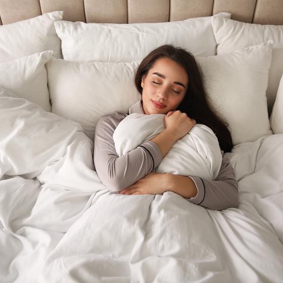 Woman in bed with duvet