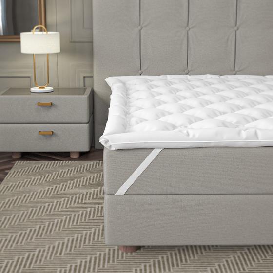 Premium mattress overlay on bed with elastic