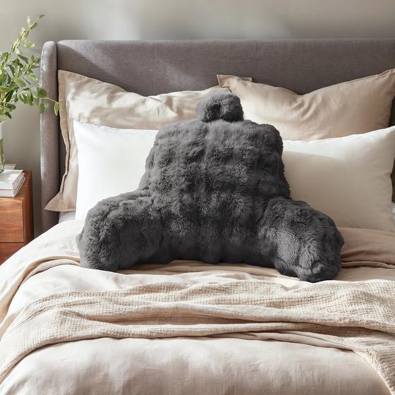 Comfortable backrest cushion pompom fur - anthracite on bed
