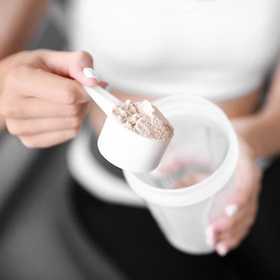 Whey protein powder is put in cup