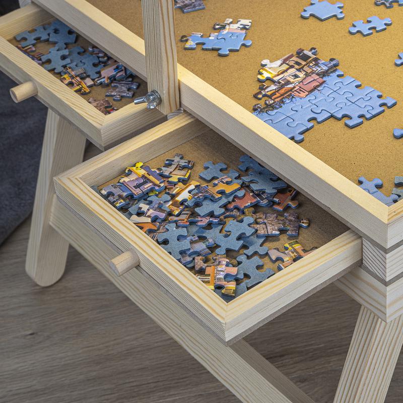 Pièces de puzzle triées et rangées dans les tiroirs de la table à puzzle