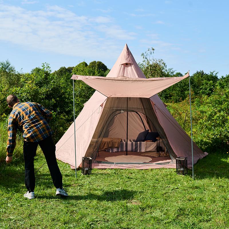 Glamping tipi tent - person with opened tent outdoors