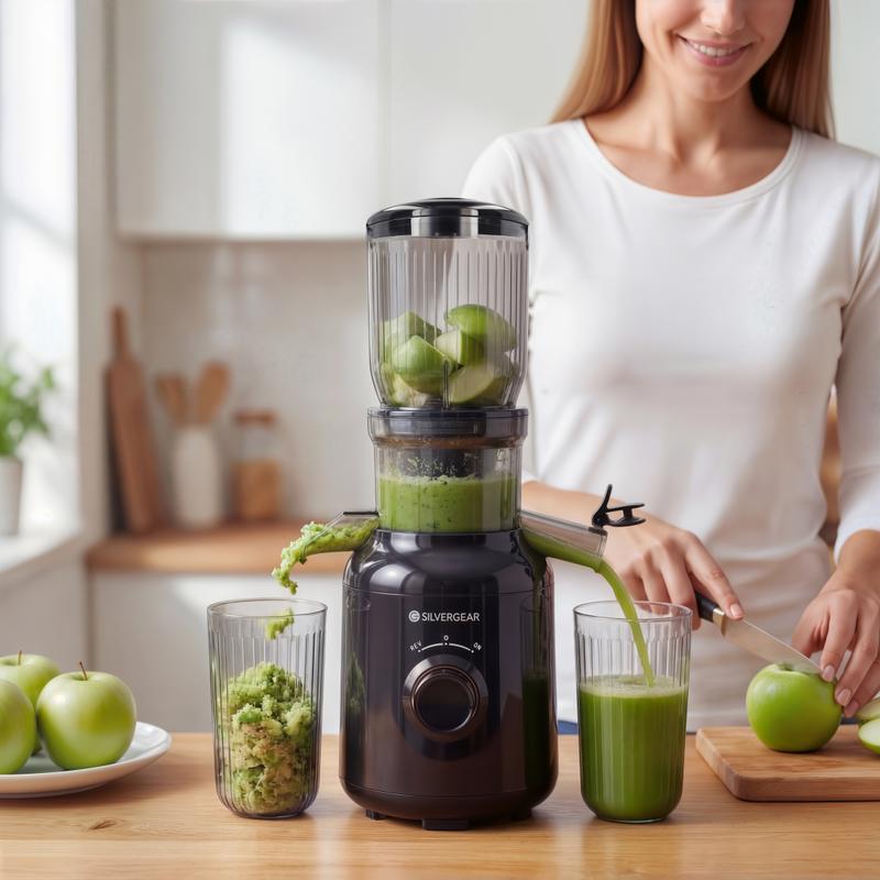 Silvergear slow juicer - shown juicing an apple
