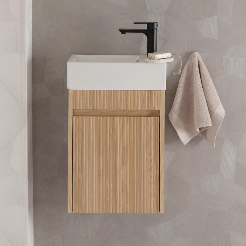 Toilet cabinet with washbasin in bathroom