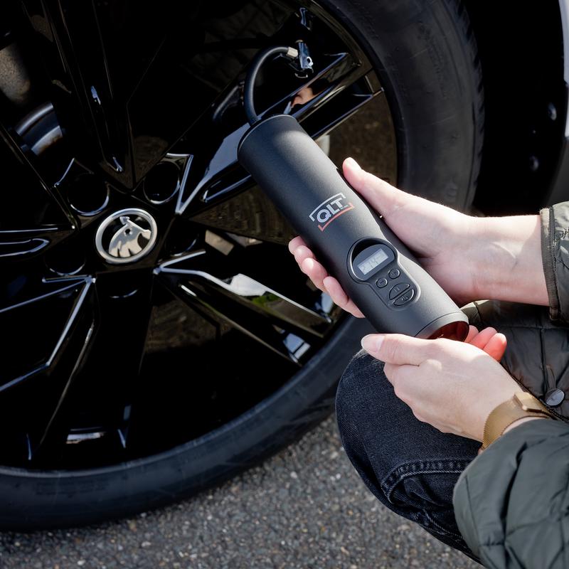 Inflating car tyres with the air compressor - close-up