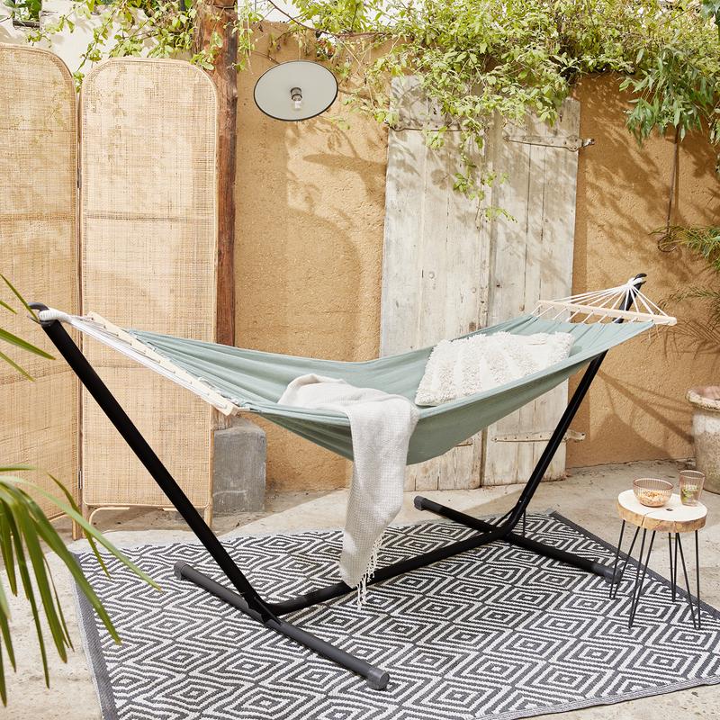 Olive green hammock with frame in the garden