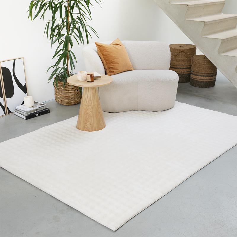 Tapis crème sous un canapé