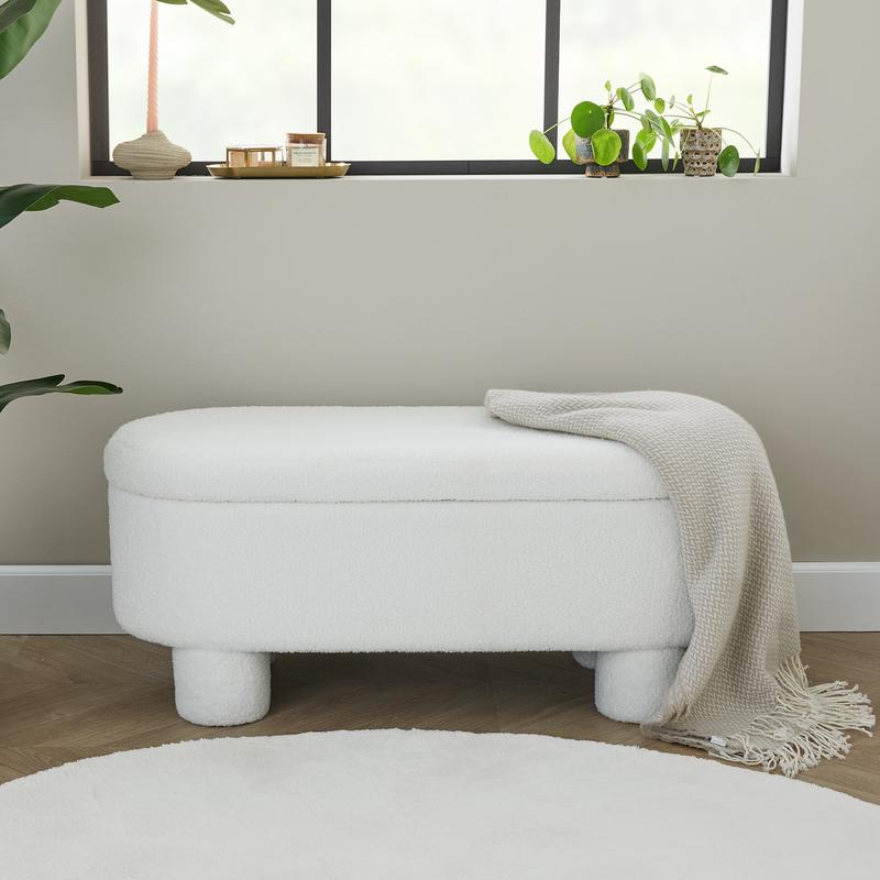 Teddy storage bench in bedroom with throw