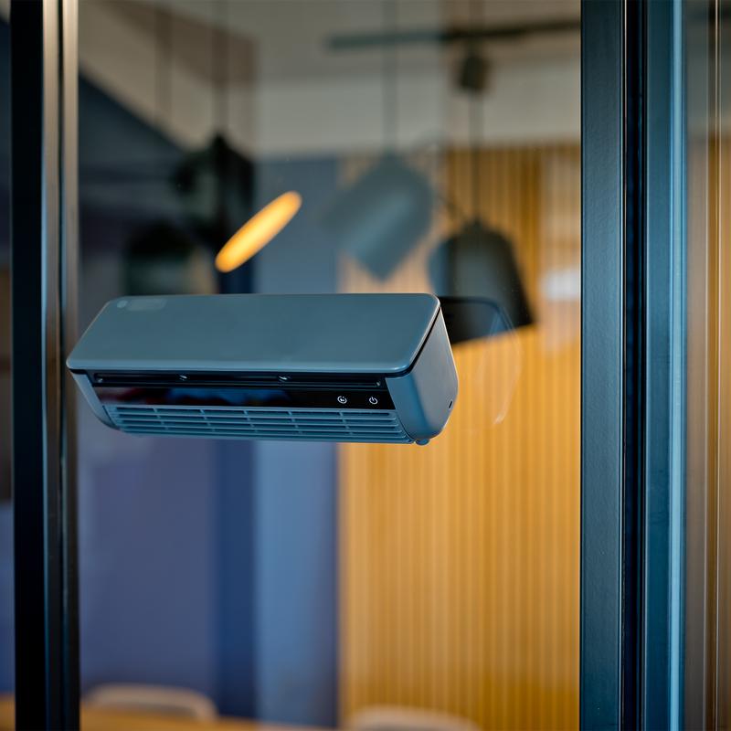 Nexxt portable air cooler fan with mist function attached to window